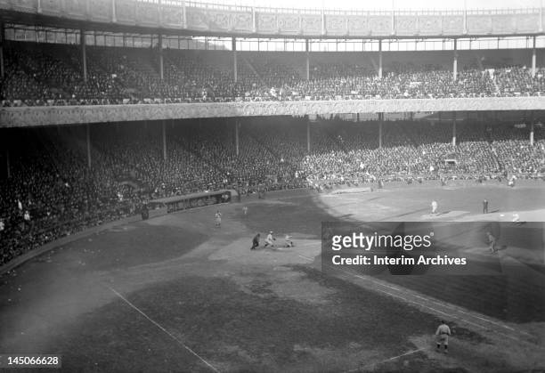Third baseman Mike McNally of the New York Yankees steals home against the New York Giants, during the first game of the World Series, held at the...