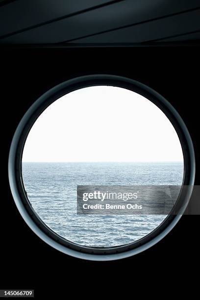 view of the sea through a porthole - patrijspoort stockfoto's en -beelden