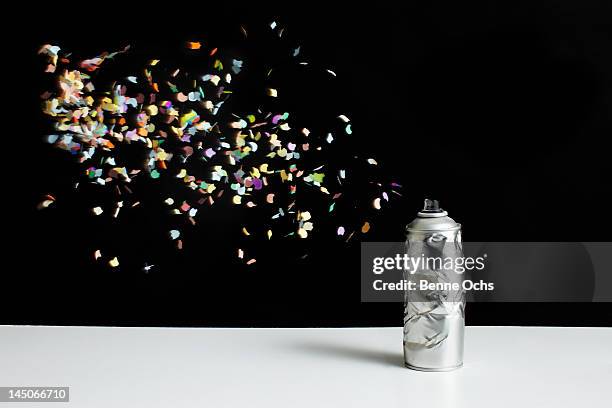 floating confetti and a damaged spray paint can - paint mid air stock pictures, royalty-free photos & images