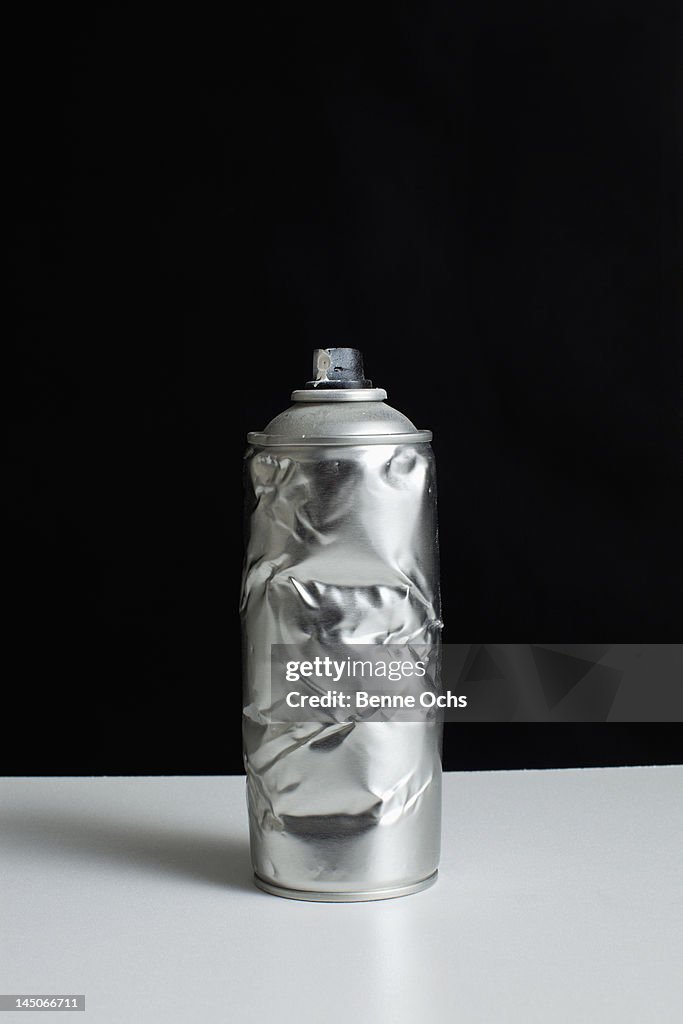 A damaged spray paint can