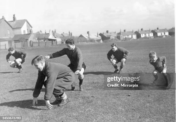 Four year old Charlie Woolett joining in the Manchester United training session in Blackpool with Bobby Charlton, Wilf McGuinness and Eddie Colman....