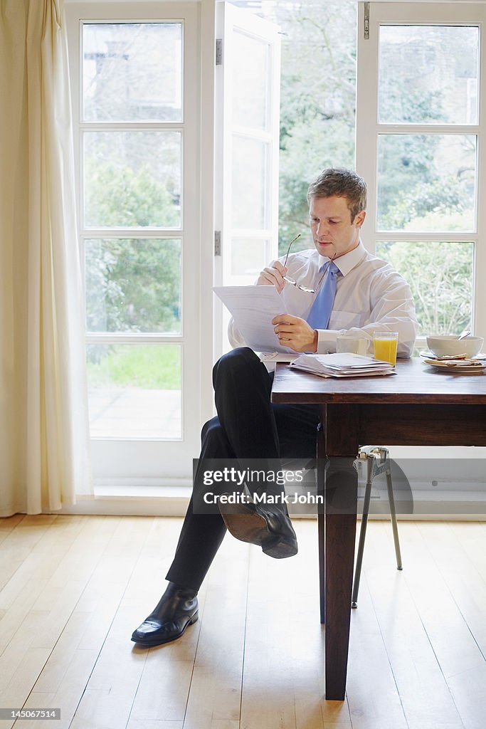 Businessman reading at breakfast