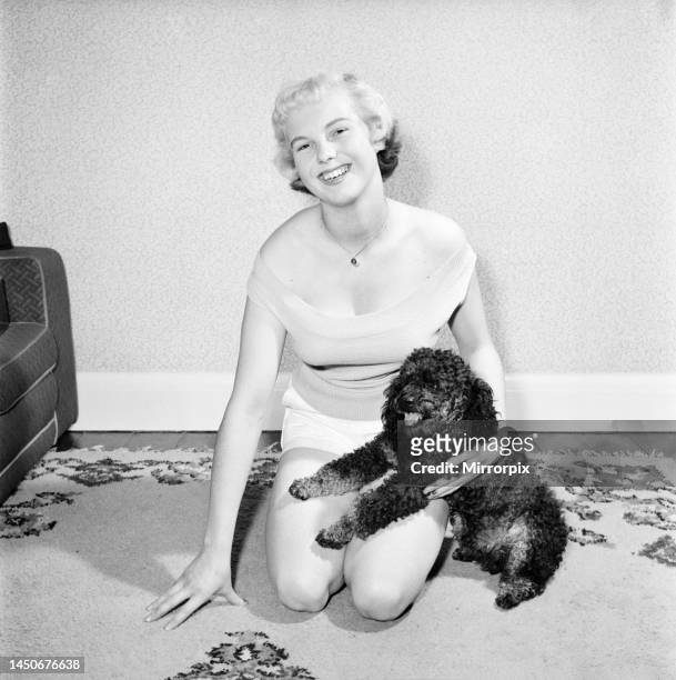 Pat Bolton seen here with her pet poodle dog. 1964.
