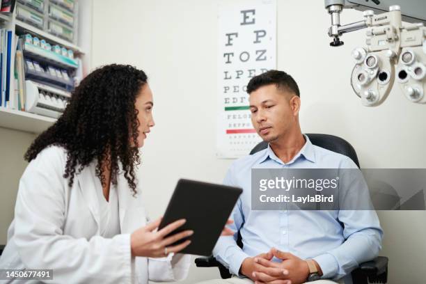 optometry, tablet and optician with man for results, communication and consulting about vision. healthcare, medical and ophthalmologist talking to a patient about eye care after an exam with tech - oftalmologista imagens e fotografias de stock