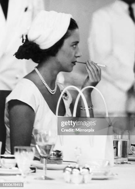 Princess Margaret at luncheon during her East Africa Tour. Pictured in Dar es Salaam using a long cigarette holder, the Princess smokes after her...