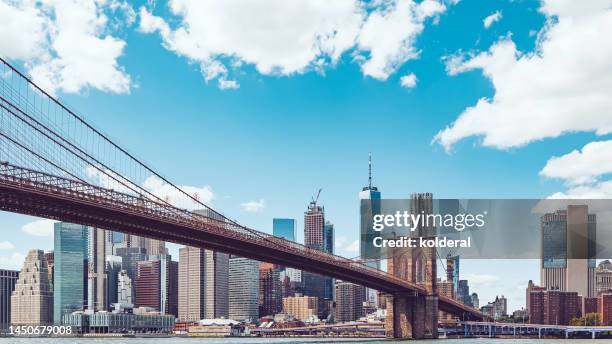 brooklyn bridge panoramic view against lower manhattan district and blue sky. new york, manhattan, usa - stad new york stockfoto's en -beelden