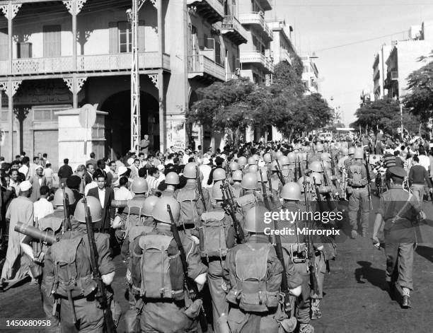 Suez Crisis 1956 - United Nations troops march into Port Said past a restless Egyptian crowd . 25th November 1956.