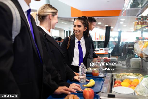 students waiting in line for school lunch - dinner stock pictures, royalty-free photos & images
