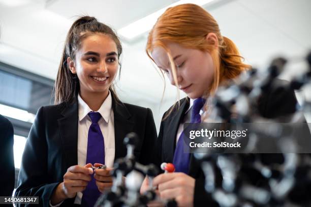 girls learning about science - secondary school uniform stock pictures, royalty-free photos & images