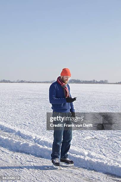 man in ice skates using cell phone - hockey talks stock pictures, royalty-free photos & images