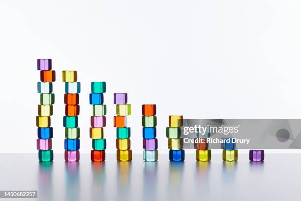 conceptual image of transparent coloured cubes - devaluación fotografías e imágenes de stock