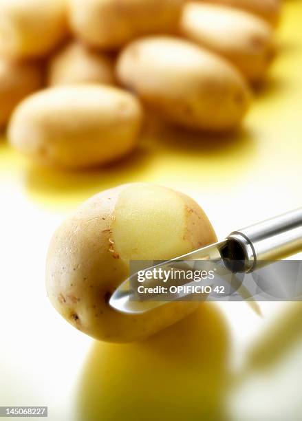 peeler removing potato skin - yukon gold stock pictures, royalty-free photos & images