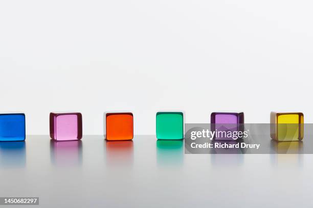 conceptual image of transparent coloured cubes - perspex stockfoto's en -beelden