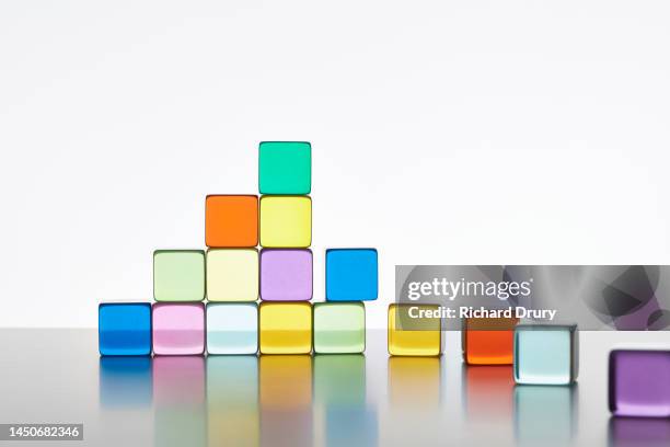 conceptual image of transparent coloured cubes - perspex stockfoto's en -beelden