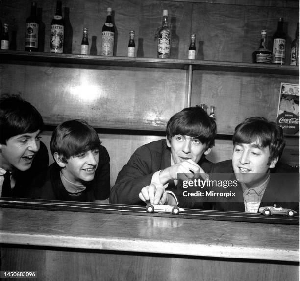 The Beatles in Coventry, amusing themselves with miniature cars before the show. 17th November 1963.