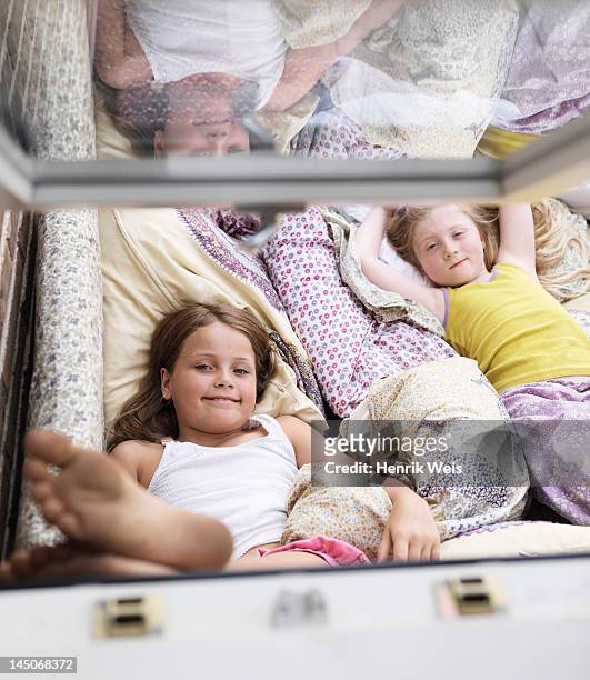 girls relaxing on sofa indoors - barefoot feet up lying down girl stockfoto's en -beelden