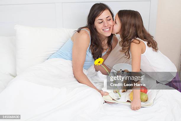 girl bringing mother breakfast in bed - mother's day breakfast stock pictures, royalty-free photos & images