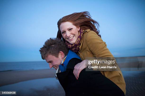 man carrying girlfriend piggyback - scotland people stock pictures, royalty-free photos & images