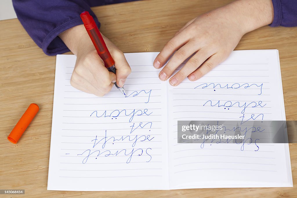 Student practicing handwriting in class