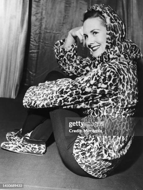 Woman wearing an Ocelot jacket hood and matching shoes. November 1955.