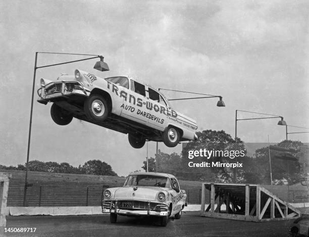 Drivers from the Trans-World Auto Daredevils also know as the Hollywood Rodeo, perform a stunt at the Brandon stadium near Coventry 18th May 1955.