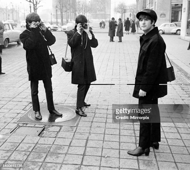 The Beatles on the Champs Elysees before Ringo arrived in Paris later in the day, Wednesday 15th January 1964. George Harrison and Paul McCartney...