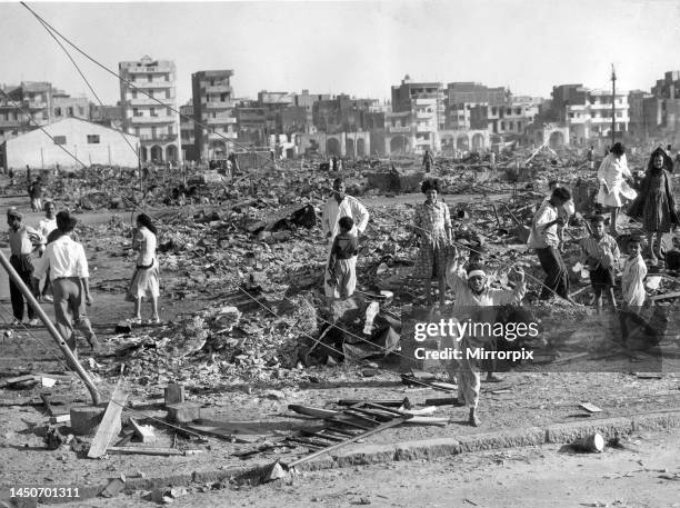 The Suez crisis - Egyptians in the Arab quarter of Port Said, clearing up the Debris and Ruins of what was once their home. 12th November 1956.