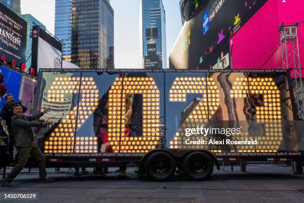 James Bell, Director of Corporate Communications of Kia America, points to the “2023” numerals after the illumination ceremony in Times Square on...