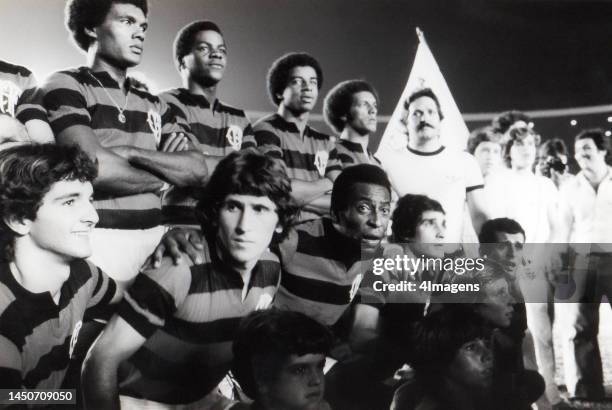 Brazilian footballer player Pelé lines up alongside Zico and the Flamengo team during a charity match in 1979 in Rio de Janeiro, Brazil.