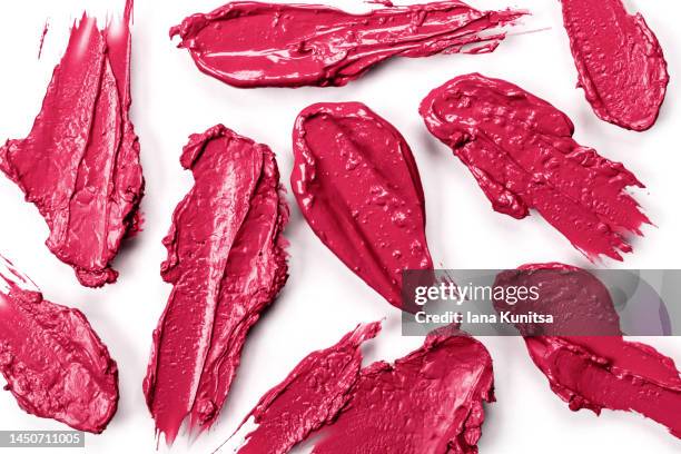 red, pink, viva magenta lipstick smears on white background, isolated. lip gloss samples are smudged. beauty cosmetic banner. makeup and skin care products. color of the year 2023. - pink lipstick smear stock pictures, royalty-free photos & images