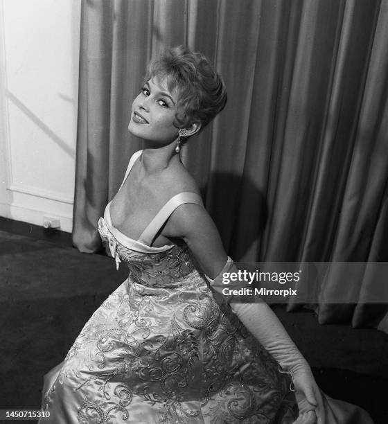 French actress Bridgitte Bardot rehearses her curtsy in anticipation of her meeting with the queen October 1956.