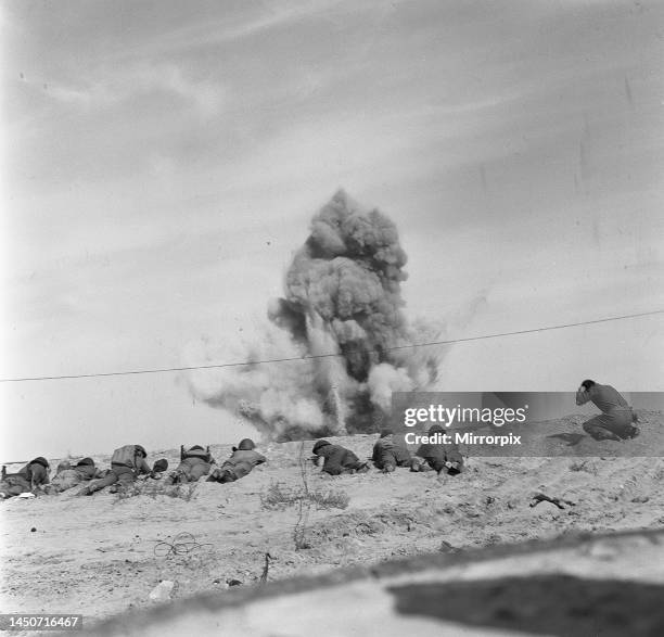 Suez Crisis 1956 - Royal Engineers take cover as they blow up a mine from a beach near Port Said which they are clearing. 23rd November 1956.