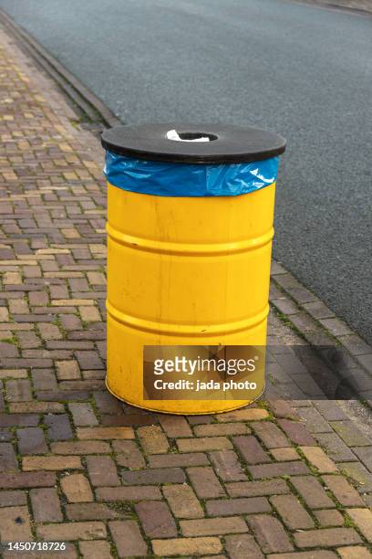 yellow steel drum for garbage dump - industrial storage bins stock pictures, royalty-free photos & images