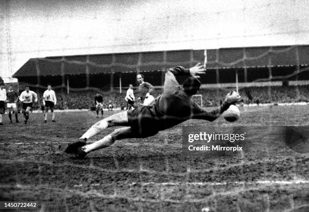 Bobby Charlton of Manchester United shoots his penalty kick at goal only to be saved by Tottenham Hotspur goalkeeper Pat Jennings during their league...