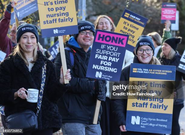 Striking Nurses acknowledges the support of passing motorists and patients as they stand on their picket line on December 20, 2022 in Cardiff, Wales....