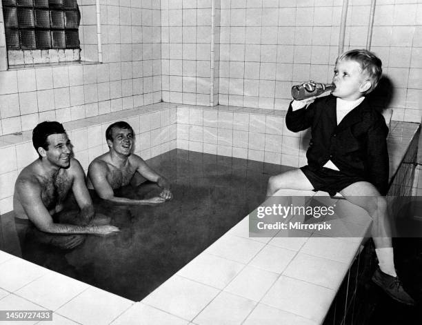 Five year old Gary Lee, son of Manchester City's injured wingman Francis Lee, having a drink from a bottle as his dad sits in the bath at Maine Road,...