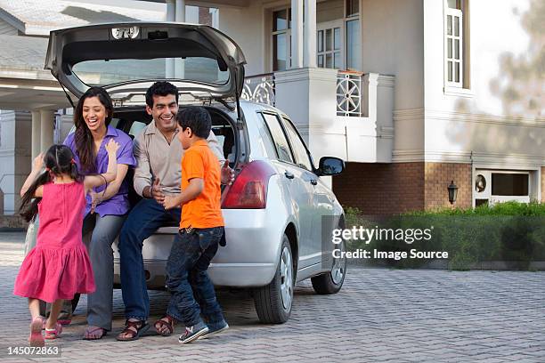 family having fun - family of four in front of house stock-fotos und bilder