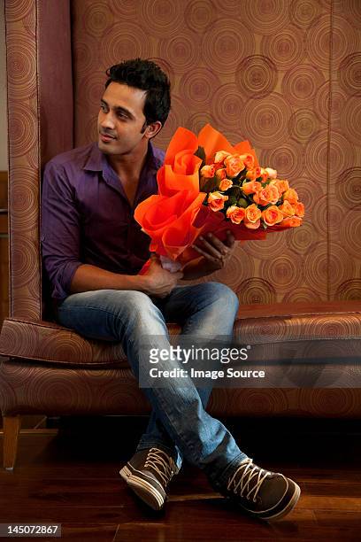 man with a bouquet of flowers - man waiting stock pictures, royalty-free photos & images