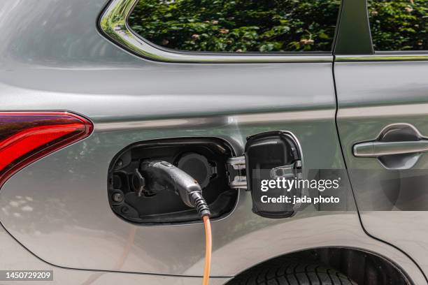a passenger car is electrically charged - hybrid car stock pictures, royalty-free photos & images