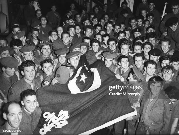 Suez Crisis 1956 - Men of the first Battalion Argyle and Sutherland Highlanders display a captued Egyptian flag as they arrive back in Southampton on...