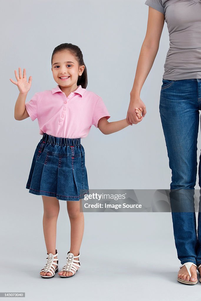 Portrait of a young girl waving