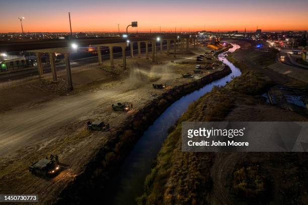 In an aerial view, Texas National Guard troops and state troopers line the bank of the Rio Grande on December 20, 2022 as viewed from Ciudad Juarez,...