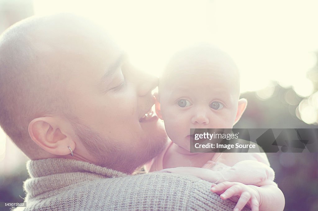 Father whispering to baby