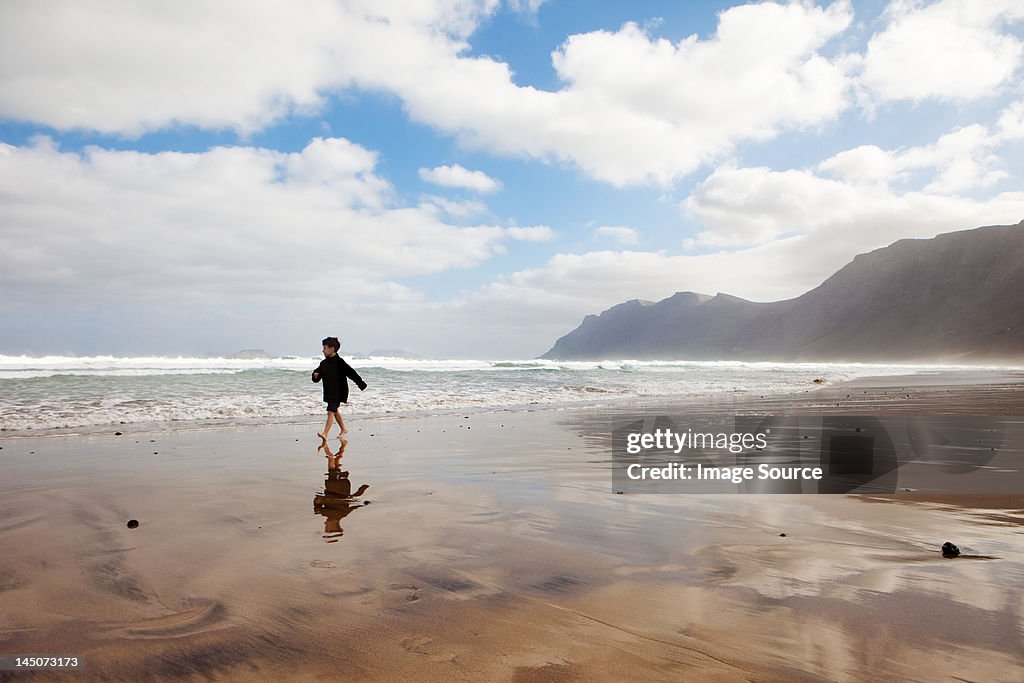 Boy running on a beach