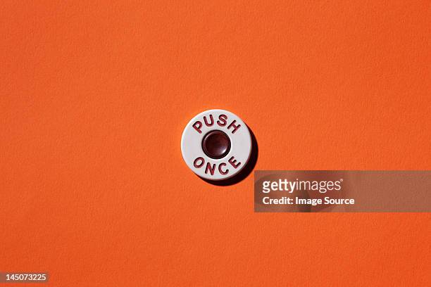 push once"" button on orange background - semplicità foto e immagini stock
