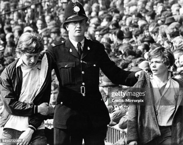 Two young Sunderland fans are ejected from the ground by a policeman during the Sunderland v Newcastle United league match at Roker Park. 31st August...