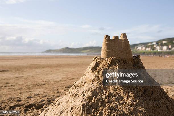 sand castle on a beach - sand pile stock pictures, royalty-free photos & images