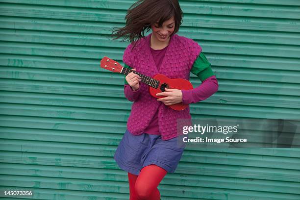 young woman playing ukulele - offbeat imagens e fotografias de stock