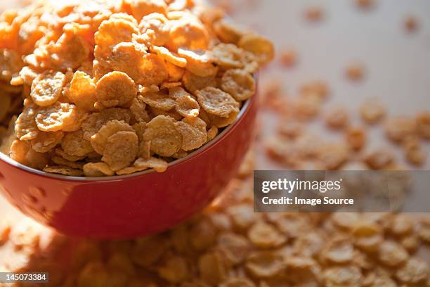 breakfast cereal flakes spilling overflowing bowl - corn flakes imagens e fotografias de stock