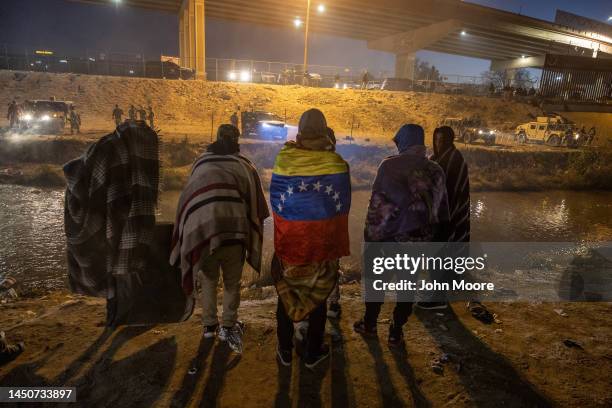 Texas National Guard troops and state police block migrants from Venezuela from entering a popular crossing area along the bank of the Rio Grande in...